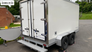 Refrigerated trailer rentals near me for caterers parked at event.